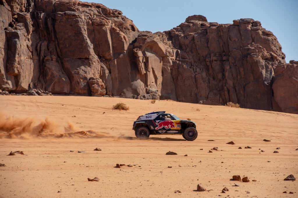 Dakar Rally car driving in desert